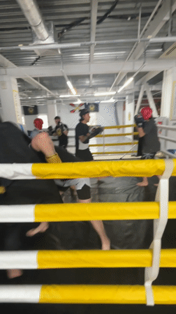 Boxing sparring session captured with four participants in ring