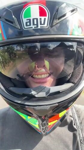 Motorcyclist records selfie video while riding in Mengwi, Indonesia