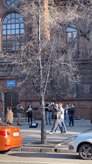 Street performance draws crowds in Krasnoyarsk as scooter riders pass