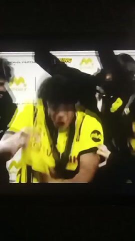 A man wearing a Borussia Dortmund soccer jersey dances near a crowd of people. The image cuts to a black screen with the M.Sport and Borussia Dortmund logos and the text "Official Betting Partner in Africa." The screen reads "To be continued" and a URL. The screen then cuts to a view from an airplane window, showing the wing of the plane against a blue sky and clouds.