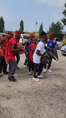 Traditional musicians perform in Jos parking lot