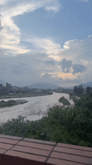 Bagmati River in flood, street life, and rooftop monkey in Lalitpur