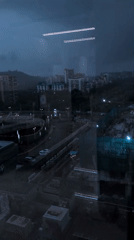 Navi Mumbai apartment towers under stormy dusk skies