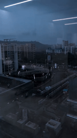 Navi Mumbai apartment towers under stormy dusk skies
