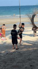 Tropical beach day with rope swings and photo props