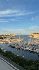 Maltese marina at golden hour, fortifications in the background