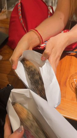 Individuals handle bundled Vietnamese currency in Thủ Đức