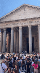 Tourist documents Rome's historic landmarks during sunny afternoon walk