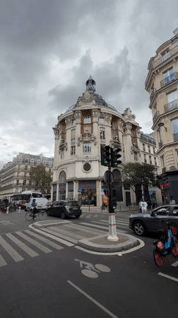 Paris street corner traffic near a domed landmark