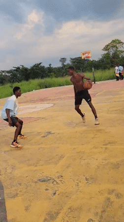Pickup basketball on a weathered outdoor court in Egbagu, Nigeria