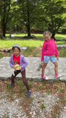 Girls play near historical monument in sunny Montenegro morning