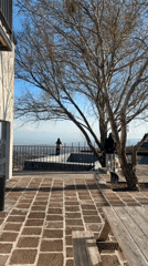 Two people enjoy city overlook from Byurakan patio