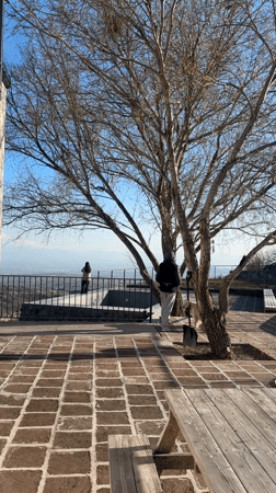 Two people enjoy city overlook from Byurakan patio
