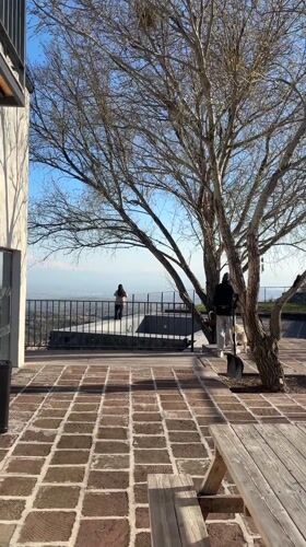 Two people enjoy city overlook from Byurakan patio