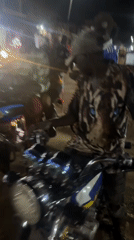 Nighttime street activity around a fruit stand in Ihiagwa