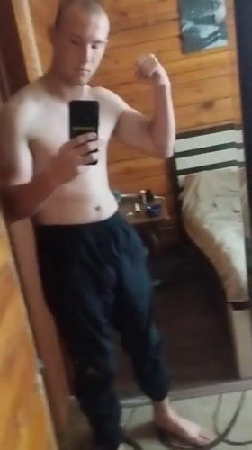 Mirror selfies in a wood-paneled room, Kirensk