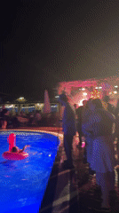 Late-night pool party in Sochi, blue lights and flamingo floaties
