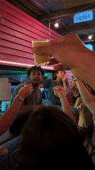 Man with megaphone rallies crowd from São Paulo bar counter