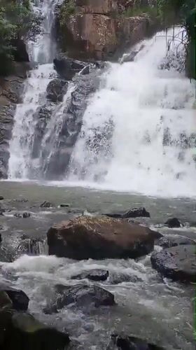 Waterfall and rocky riverbed in Da Lat's forested hills