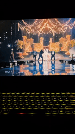 Milan resident uses backlit laptop viewing music video, logo animation