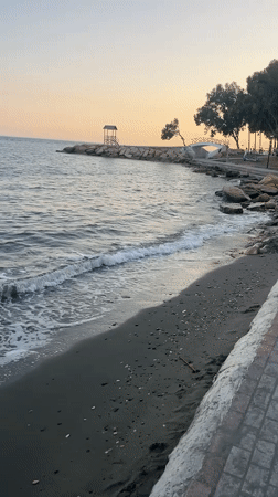 Dusk along Agios Tychona's dark-sand beachfront promenade, Cyprus