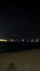 Nighttime beach gathering captured in Nha Trang, Vietnam