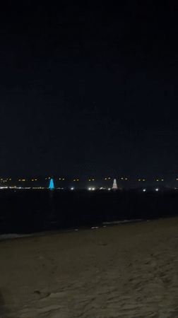 Nighttime beach gathering captured in Nha Trang, Vietnam