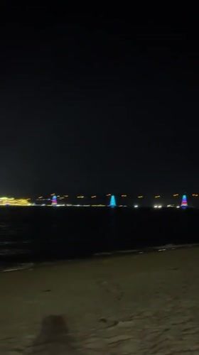 Nighttime beach gathering captured in Nha Trang, Vietnam