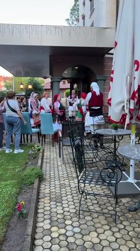 Traditional folk dancers perform in Kyustendil Bulgaria courtyard