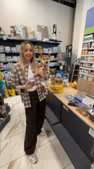 Woman holds Shiba Inu dog in Carnikava pet store