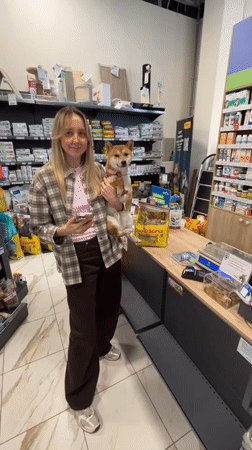 Woman holds Shiba Inu dog in Carnikava pet store