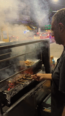 São Paulo side street buzzing with murals, food stalls, and night commerce