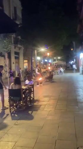 Outdoor festival night in Barcelona with live DJ and street performers