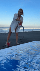 Abstract canvas painting session on a black sand Bali beach