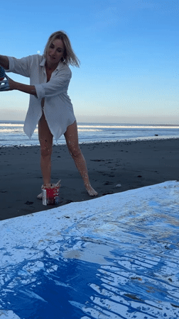 Abstract canvas painting session on a black sand Bali beach