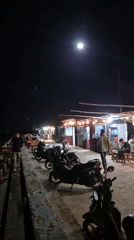 Evening food market bustling under bright moon in Lhokseumawe