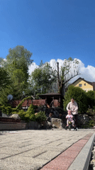 Child rides tricycle on sunny morning in Wisła, Poland