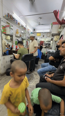 Routine barbershop activities documented in Delhi during evening hours