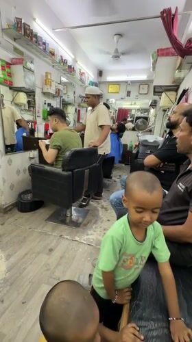 Routine barbershop activities documented in Delhi during evening hours