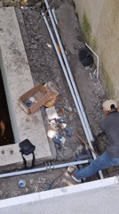 Construction worker performs plumbing work in Kuta Selatan