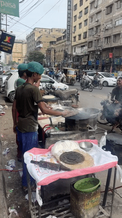 Street food and loaded motorbike scenes from midday Karachi