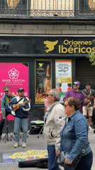 Street musicians perform outside Madrid shop with ukuleles, drums