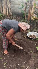 Woman gardens with hand hoe in Oboama, Nigeria
