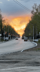 Dramatic sunset captured on tree-lined Chaikovsky street with pedestrians