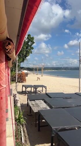 Kampoeng Seafood's beachfront tables and swing, Jimbaran Bay