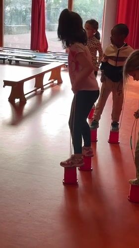 Children practice balance activities at La Fouillouse gymnasium