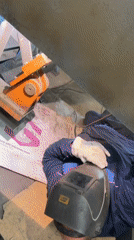Welder performs floor-level work at Pleven industrial facility