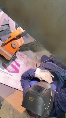 Welder performs floor-level work at Pleven industrial facility