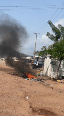 Trash fire burns on roadside in Lokoja, Nigeria