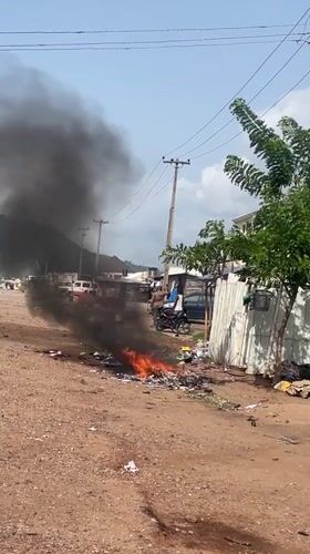 Trash fire burns on roadside in Lokoja, Nigeria